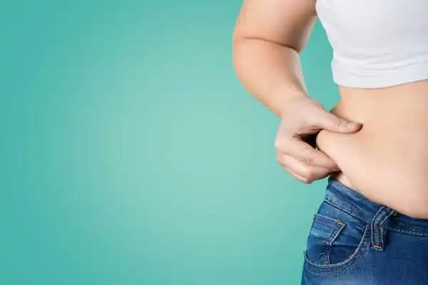 Image of woman pinching her love handles to show weight gain Leigh on Sea