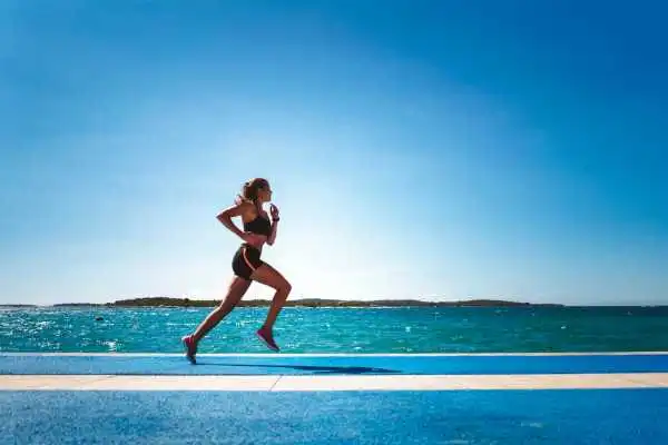 Woman running showing strong leg muscle Leigh on Sea